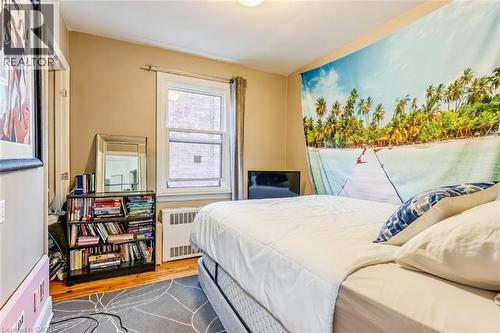 Bedroom with wood finished floors and radiator - 172 Markland Street, Hamilton, ON - Indoor Photo Showing Bedroom