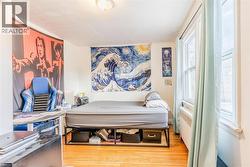 Bedroom featuring light wood-type flooring and radiator - 