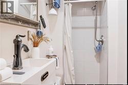 Bathroom featuring a shower with curtain and vanity - 