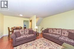 Living area with wood finished floors and baseboards - 