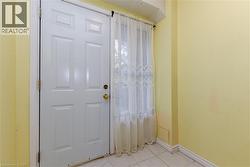 Tiled foyer entrance featuring baseboards - 