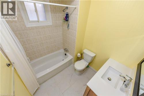 Bathroom with vanity, shower / bath combo with shower curtain, and tile patterned flooring - 85 Enmount Drive, Brampton, ON - Indoor Photo Showing Bathroom