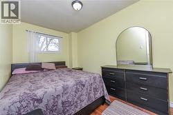 Bedroom featuring wood finished floors and a textured ceiling - 
