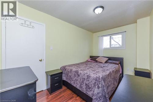 Bedroom featuring dark wood-style floors and a textured ceiling - 85 Enmount Drive, Brampton, ON - Indoor Photo Showing Bedroom