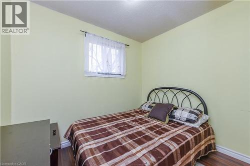 Bedroom featuring dark wood finished floors and a textured ceiling - 85 Enmount Drive, Brampton, ON - Indoor Photo Showing Bedroom