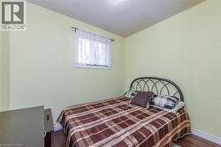 Bedroom featuring dark wood finished floors and a textured ceiling - 