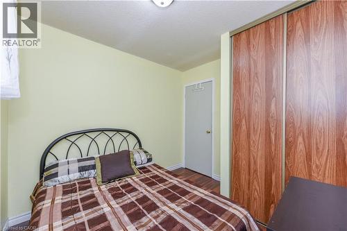 Bedroom with wood finished floors, a textured ceiling, and a closet - 85 Enmount Drive, Brampton, ON - Indoor Photo Showing Bedroom