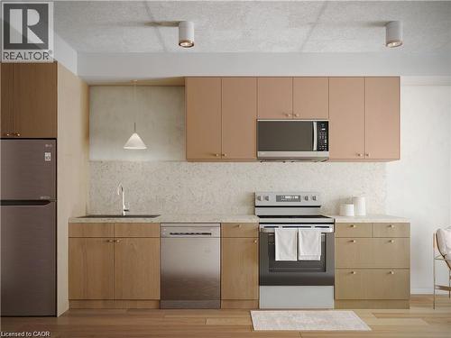 Kitchen with stainless steel appliances, light stone counters, backsplash, light wood-style flooring, and a textured ceiling - 580 Coldstream Drive Unit# 212, Waterloo, ON - Indoor Photo Showing Kitchen