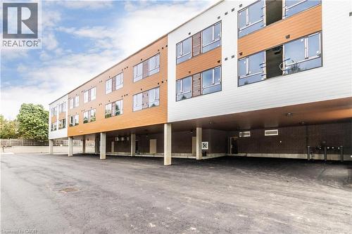 View of apartment building / complex with covered parking - 580 Coldstream Drive Unit# 212, Waterloo, ON - Outdoor