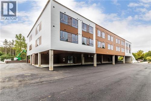View of property featuring covered parking - 580 Coldstream Drive Unit# 212, Waterloo, ON - Outdoor