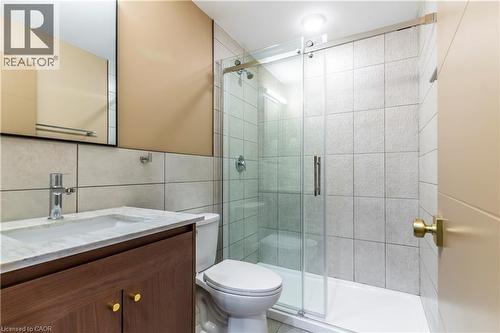 Full bathroom featuring vanity, a stall shower, and tile walls - 580 Coldstream Drive Unit# 212, Waterloo, ON - Indoor Photo Showing Bathroom
