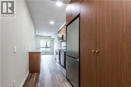 Kitchen with appliances with stainless steel finishes, dark wood finished floors, recessed lighting, and modern cabinets - 580 Coldstream Drive Unit# 212, Waterloo, ON - Indoor