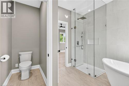 Bathroom featuring a stall shower, a freestanding bath, and a ceiling fan - 4006 Flemish Drive, Burlington, ON - Indoor Photo Showing Bathroom