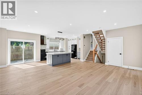 Kitchen featuring decorative light fixtures, a center island, gray cabinets, tasteful backsplash, and recessed lighting - 4006 Flemish Drive, Burlington, ON - Indoor