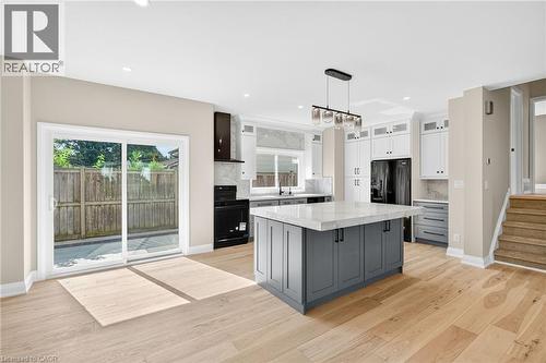 Kitchen with gray cabinets, white cabinetry, black range with electric stovetop, pendant lighting, and a kitchen island - 4006 Flemish Drive, Burlington, ON - Indoor Photo Showing Kitchen