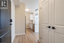 Hallway featuring sink and light hardwood / wood-style flooring - 