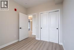 Unfurnished bedroom with a closet and light wood-type flooring - 