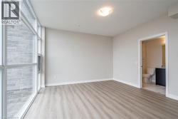 Spare room featuring light hardwood / wood-style flooring and floor to ceiling windows - 