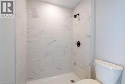 Bathroom with tiled shower and toilet - 