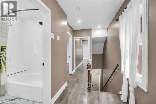 Full bathroom featuring shower / tub combo with curtain, wood finished floors, and recessed lighting - 334 Cannon Street E, Hamilton, ON - Indoor