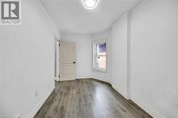 Spare room with wood finished floors and baseboards - 