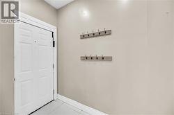 Doorway to outside featuring tile patterned flooring and baseboards - 