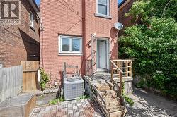 View of exterior entry featuring brick siding - 