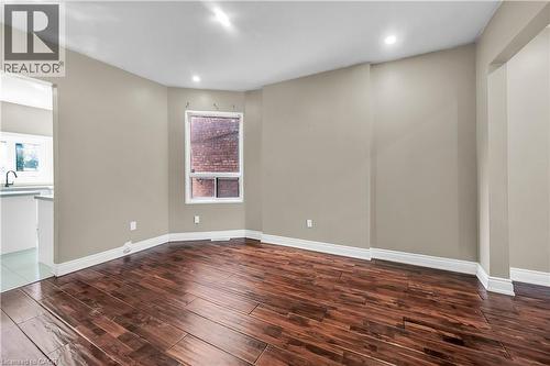 Spare room featuring dark wood finished floors, healthy amount of natural light, and recessed lighting - 334 Cannon Street E, Hamilton, ON - Indoor Photo Showing Other Room