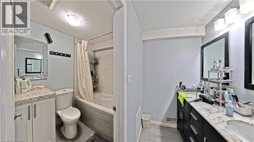 Full bath with double vanity and shower / bathtub combination with curtain - 61 Bosworth Crescent, Kitchener, ON - Indoor Photo Showing Bathroom