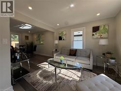 Living room featuring wood finished floors, plenty of natural light, and recessed lighting - 
