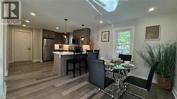 Dining space with dark wood-type flooring and recessed lighting - 