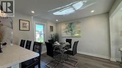 Dining area with dark wood-style floors and recessed lighting - 