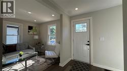 Entrance foyer featuring dark wood-style floors and recessed lighting - 