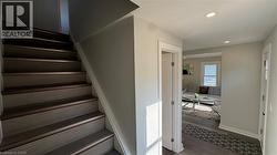 Stairway with recessed lighting and wood finished floors - 
