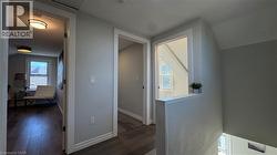Corridor featuring healthy amount of natural light, dark wood finished floors, and lofted ceiling - 