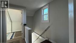 Stairway featuring wood finished floors - 