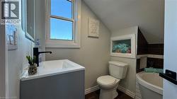 Bathroom with lofted ceiling, a bath, and vanity - 