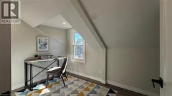 Home office with vaulted ceiling, wood finished floors, and recessed lighting - 