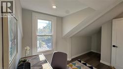 Office featuring dark wood-style flooring and baseboards - 