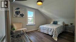 Bedroom with vaulted ceiling and wood finished floors - 
