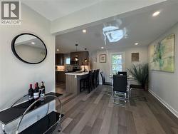 Dining space with dark wood finished floors and recessed lighting - 