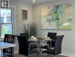 Dining room featuring wood finished floors - 