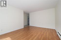 Spare room featuring a baseboard heating unit and light wood-style floors - 