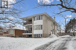 Snow covered house with a balcony and a chimney - 