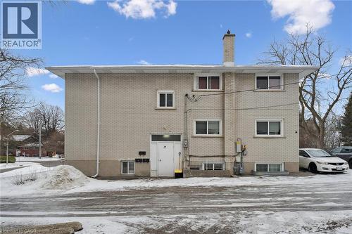 Snow covered house with brick siding and a chimney - 24 Austin Drive, Waterloo, ON - Outdoor