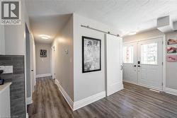 Entryway with dark wood-type flooring and a barn door - 