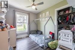 Bedroom with wood finished floors, a closet, and a ceiling fan - 
