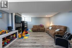 Living area with wood finished floors and recessed lighting - 