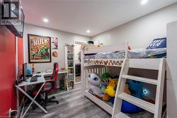 Bedroom featuring light wood finished floors and an office area - 