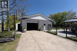 View of home's exterior with a garage, driveway, a gazebo, and stucco siding - 